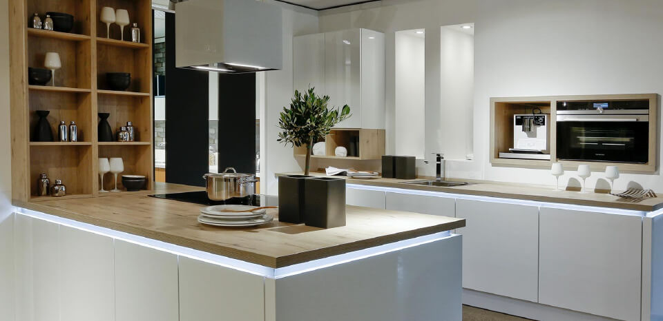 Modern White coloured theme based kitchen with a wooden touch to it