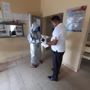 JAT Holdings employee handing out hand sanitizers to a dispensary