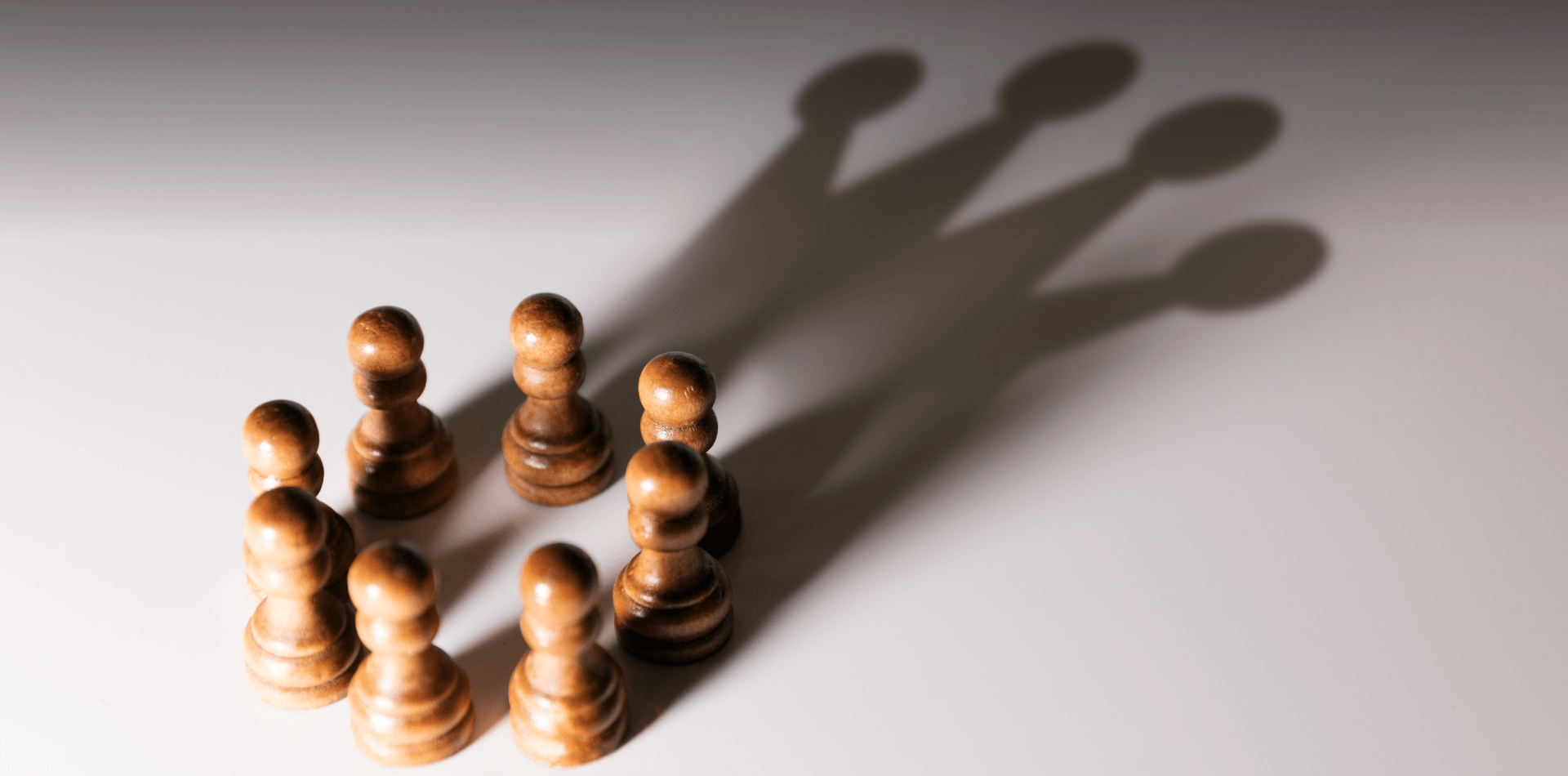 A group of pawns shadows creating a crown