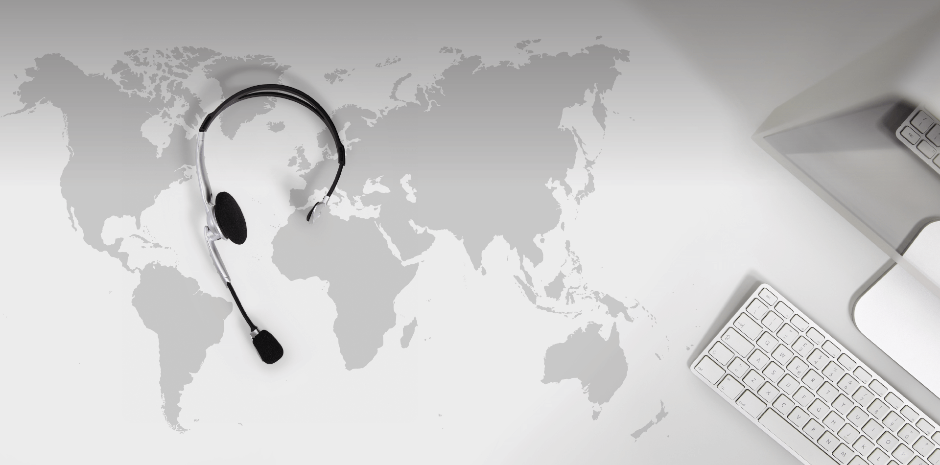 Headphones and a keyboard on top of a world map