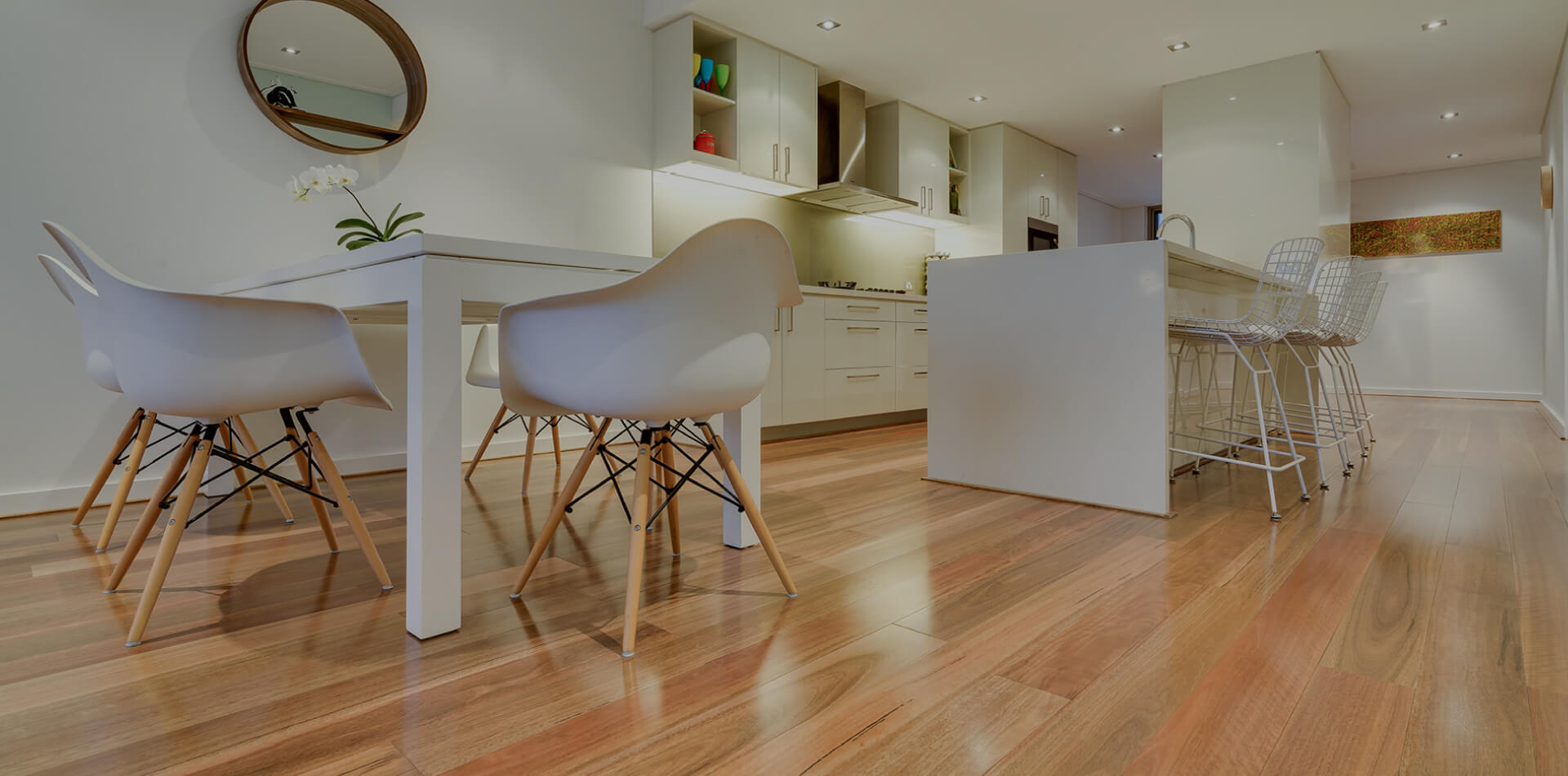 Room with wooden flooring and small wooden legged chairs